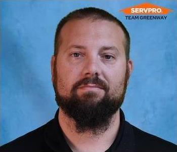 male employee wearing a black SERVPRO shirt 